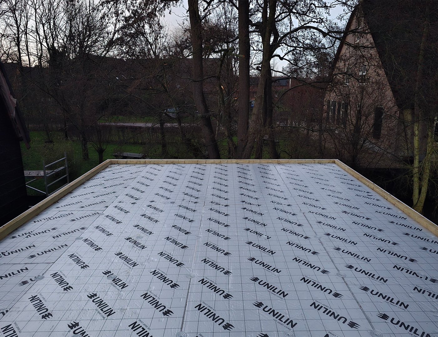 The same roof before the roofing went on, with freshly laid insulation boards on the timber decking